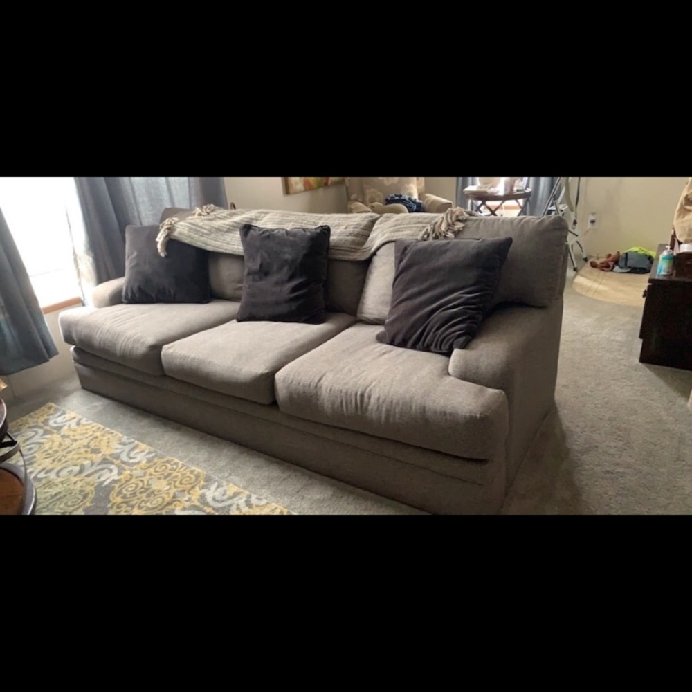 gray couch with lots of pillows